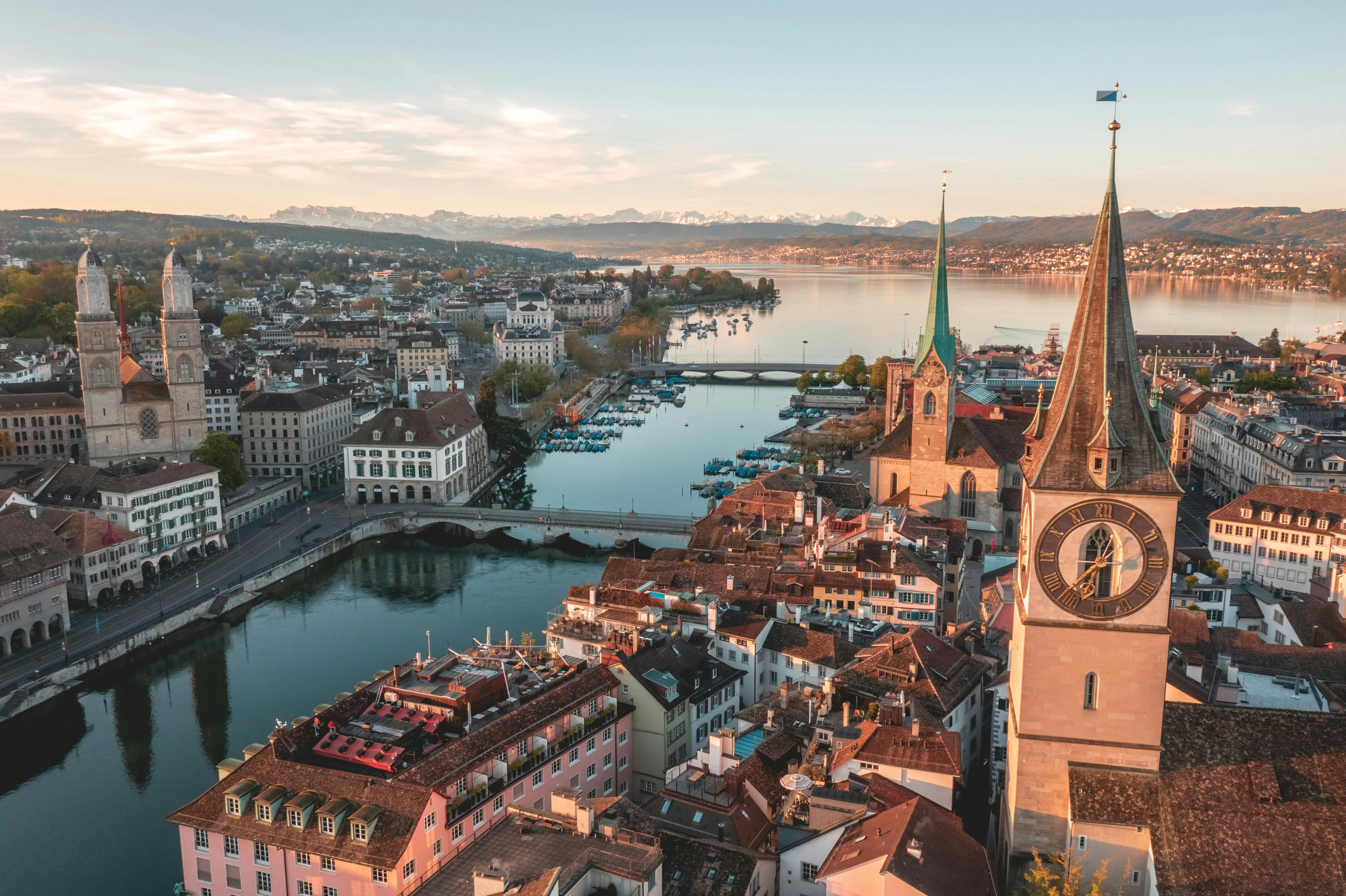 Aerial view of Zurich's old town, the Limmat river and lake, with the Alps on the horizon